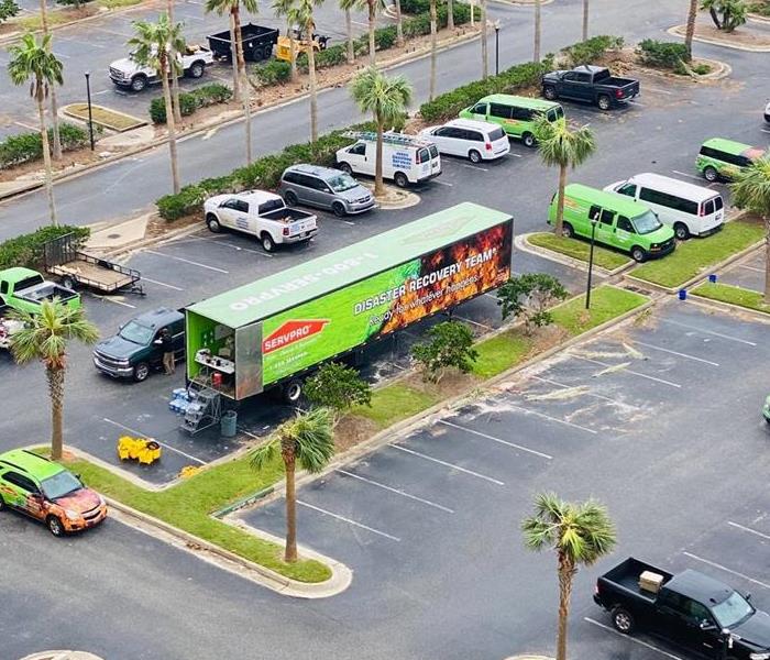 SERVPRO vehicles in front of condominium following hurricane